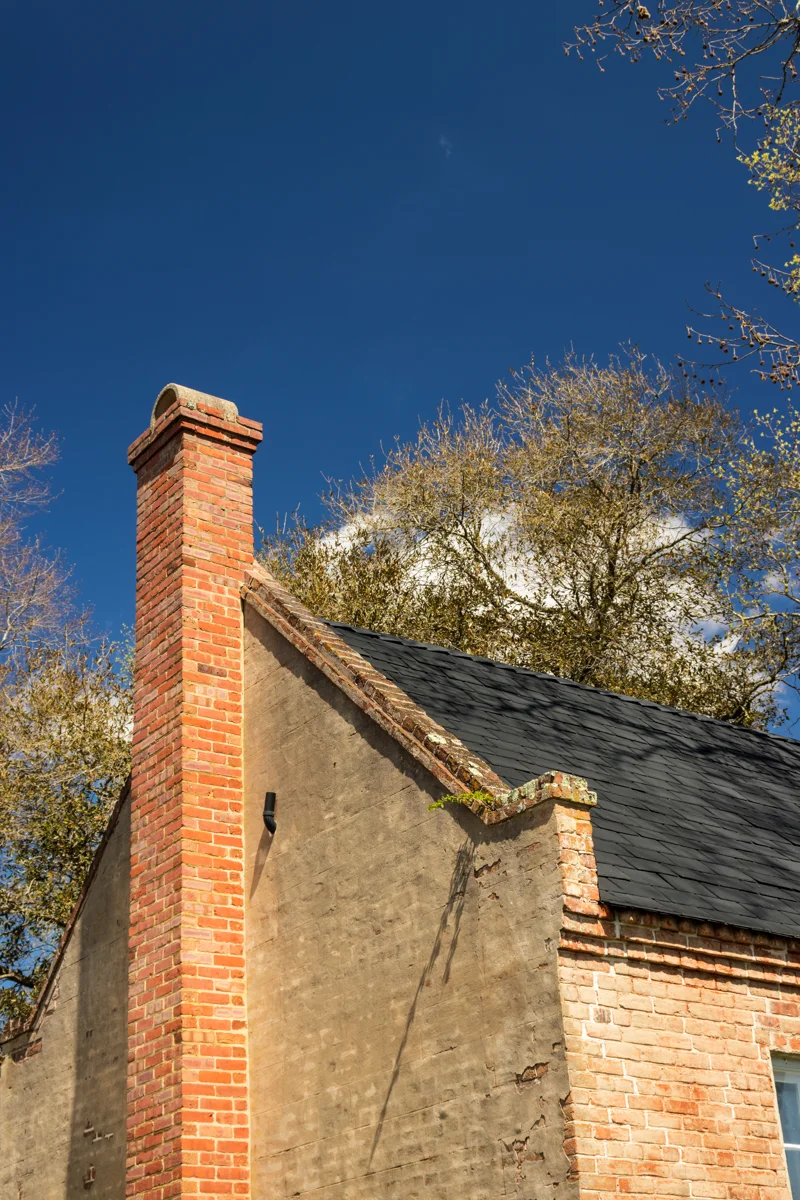 Brick chimney on a sloped roof for chimney inspection